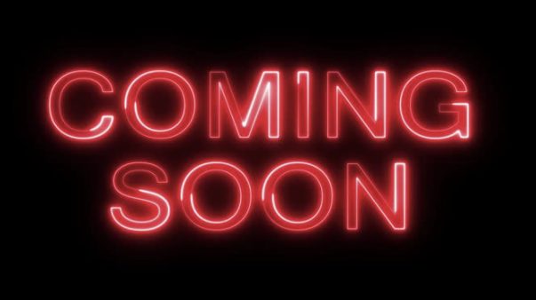 A red neon sign that reads Coming Soon